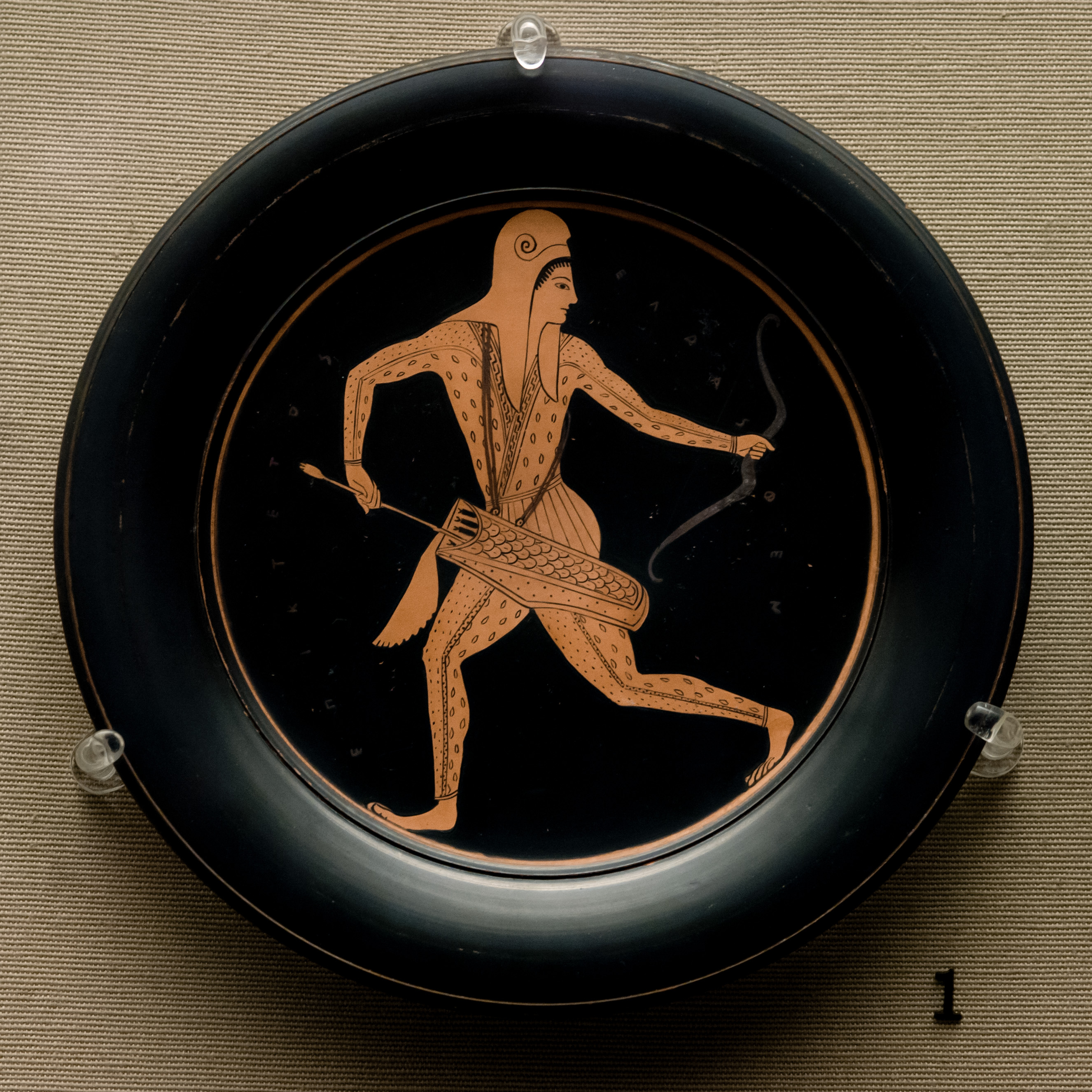 Attic red-figured Pinax. Diameter: 19.5 cm Height: 1.9 cm. Attributed to Epiktetos by signature. Made in Athens about 520-510 BC; from Vulci, Etruria.