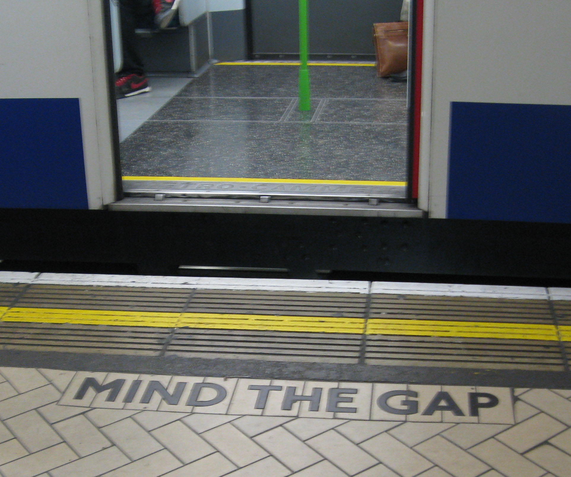 "Mind the gap" shaped tiling on the District line platform at Victoria station, by WillMcC